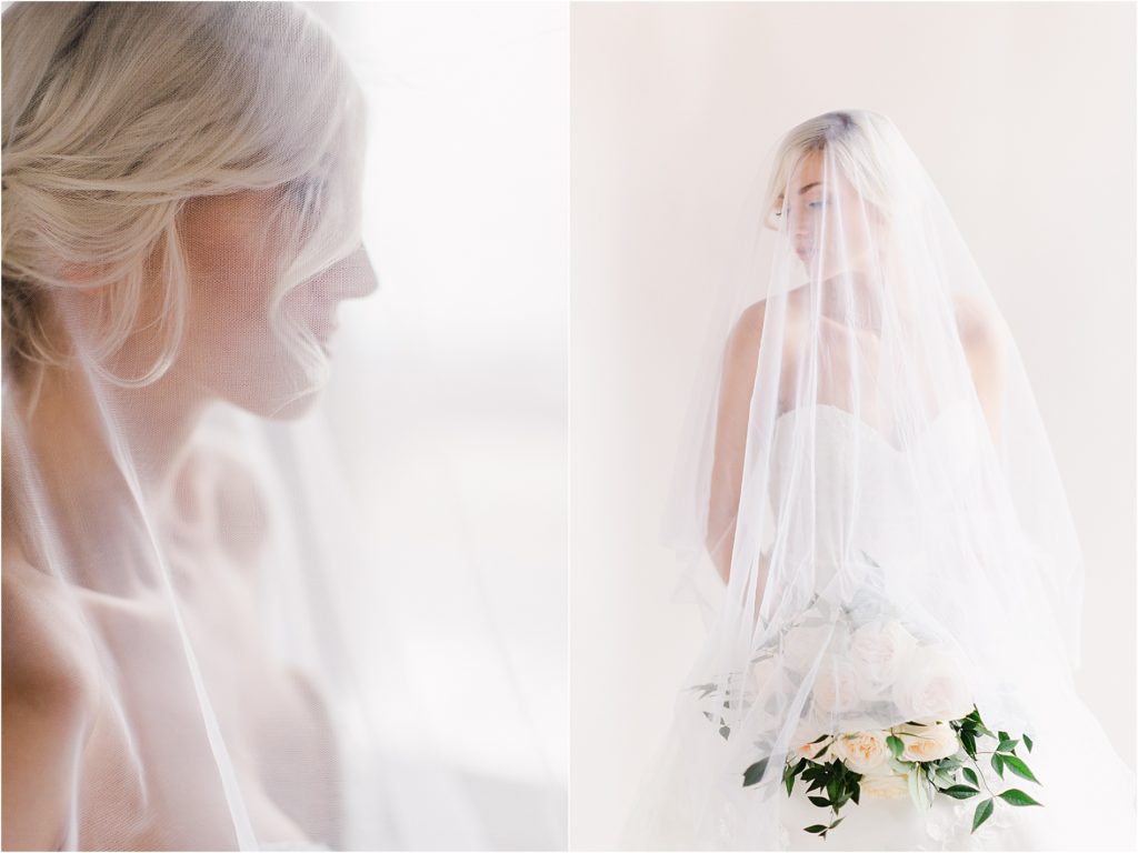 Bride wearing sheer tulle veil, looking over her shoulder, holding bouquet